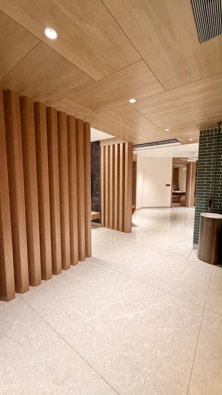 Interior passage with timber slats and a wood-clad ceiling