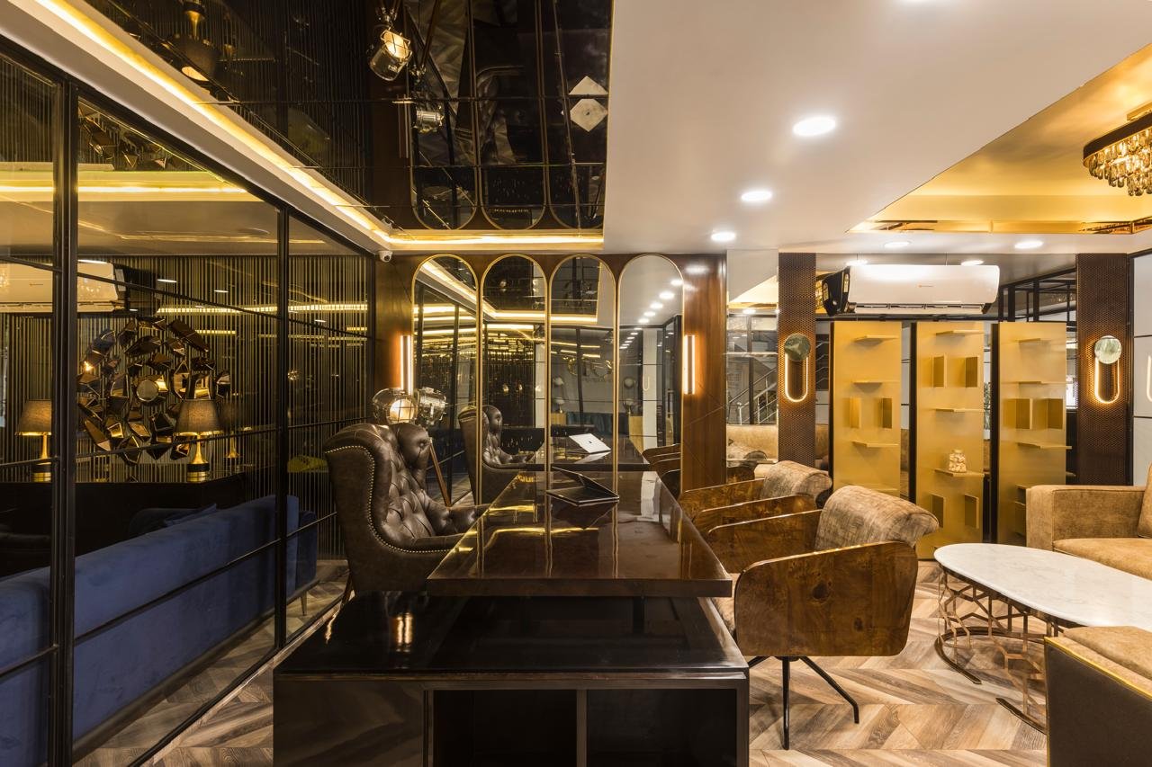 Office meeting area with glass walls and warm brass lighting