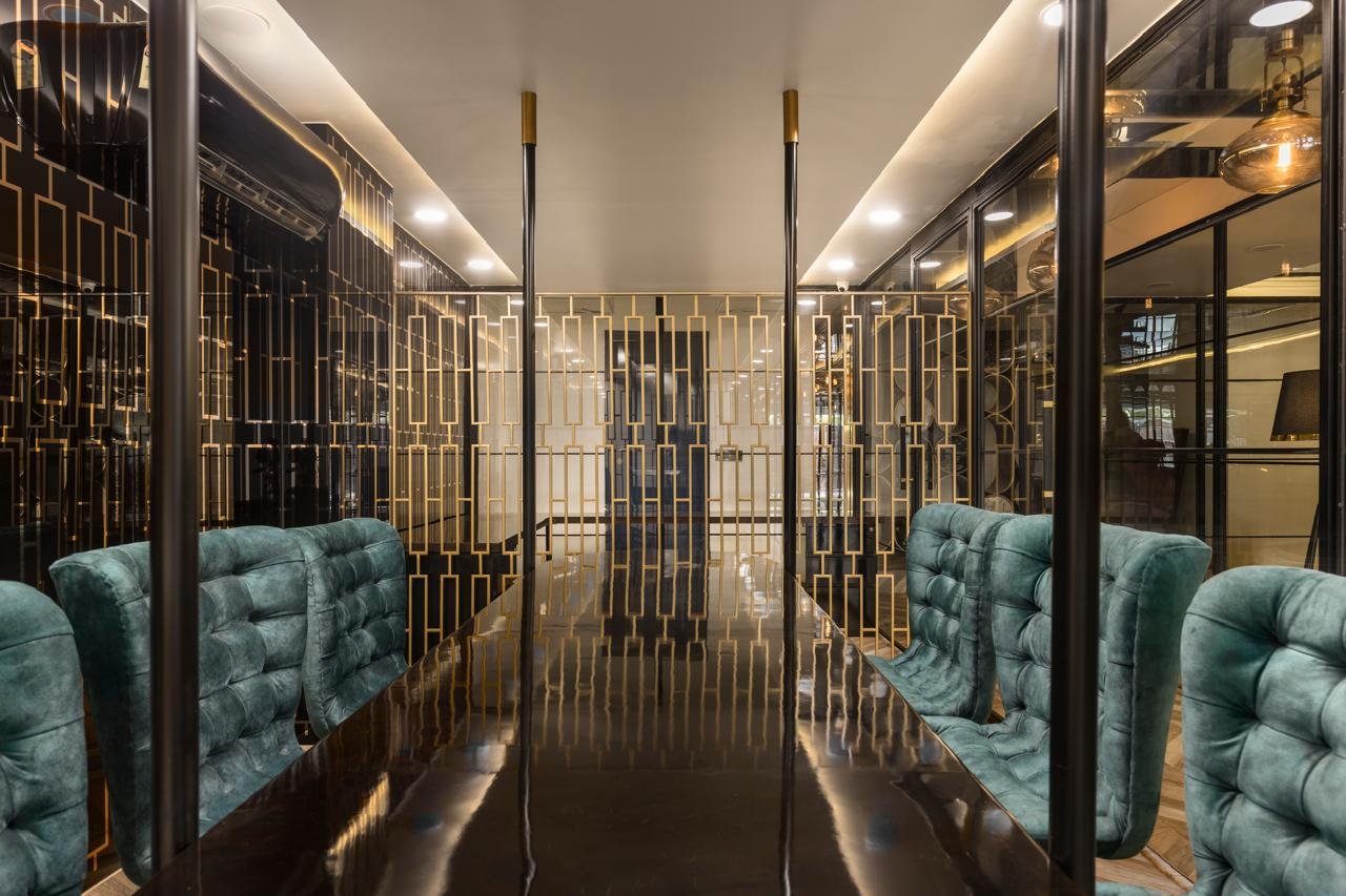 Office corridor framed by decorative mirrored panels