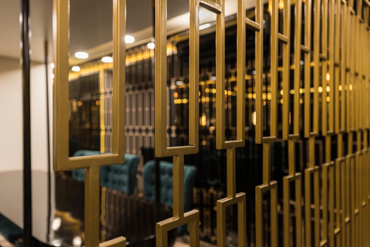 Close view of a black and brass metal partition