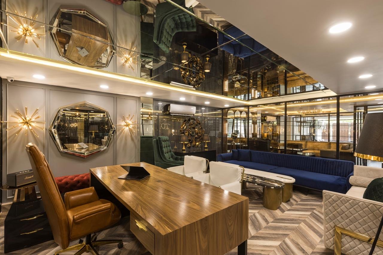 Office dining and meeting table with blue sofa and mirrored ceiling