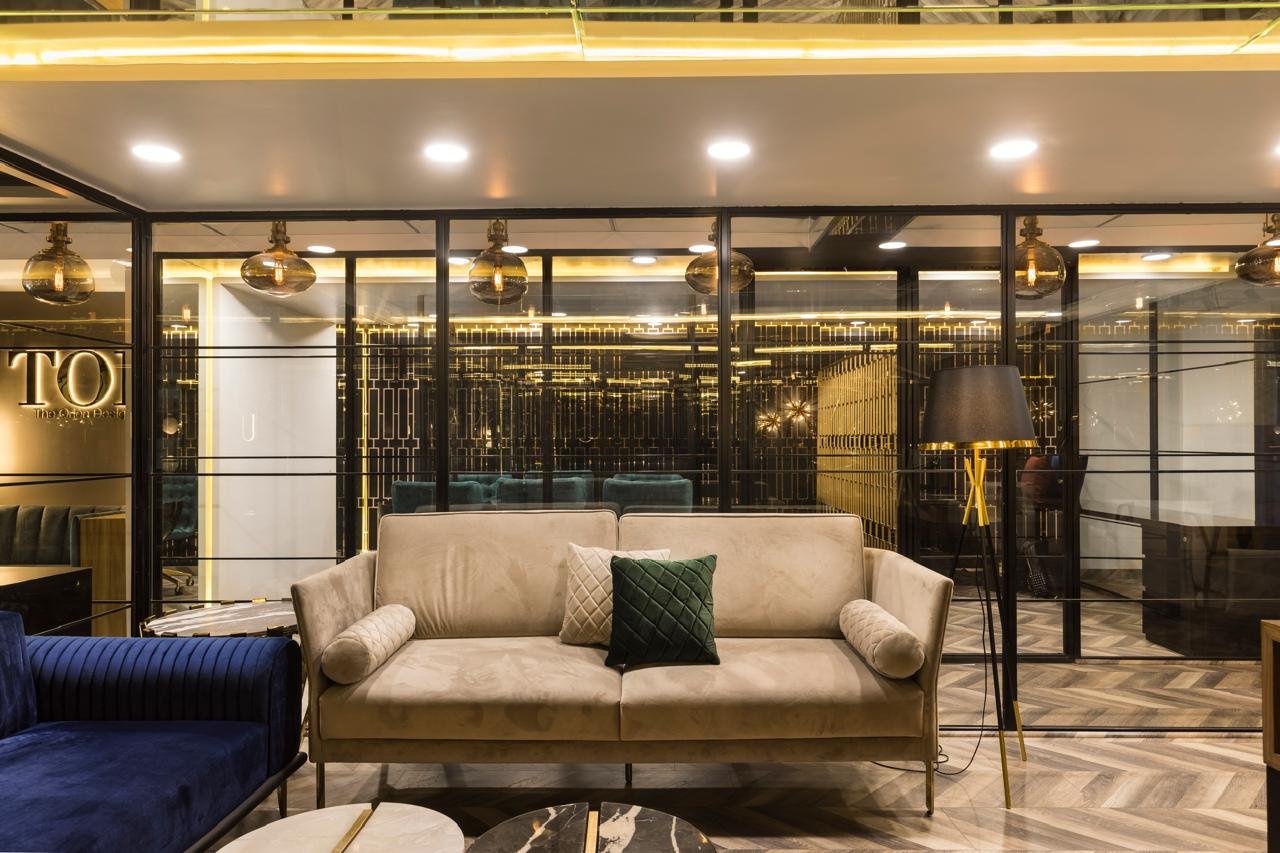 Office lounge with cream sofa and the TOD wall sign in the background