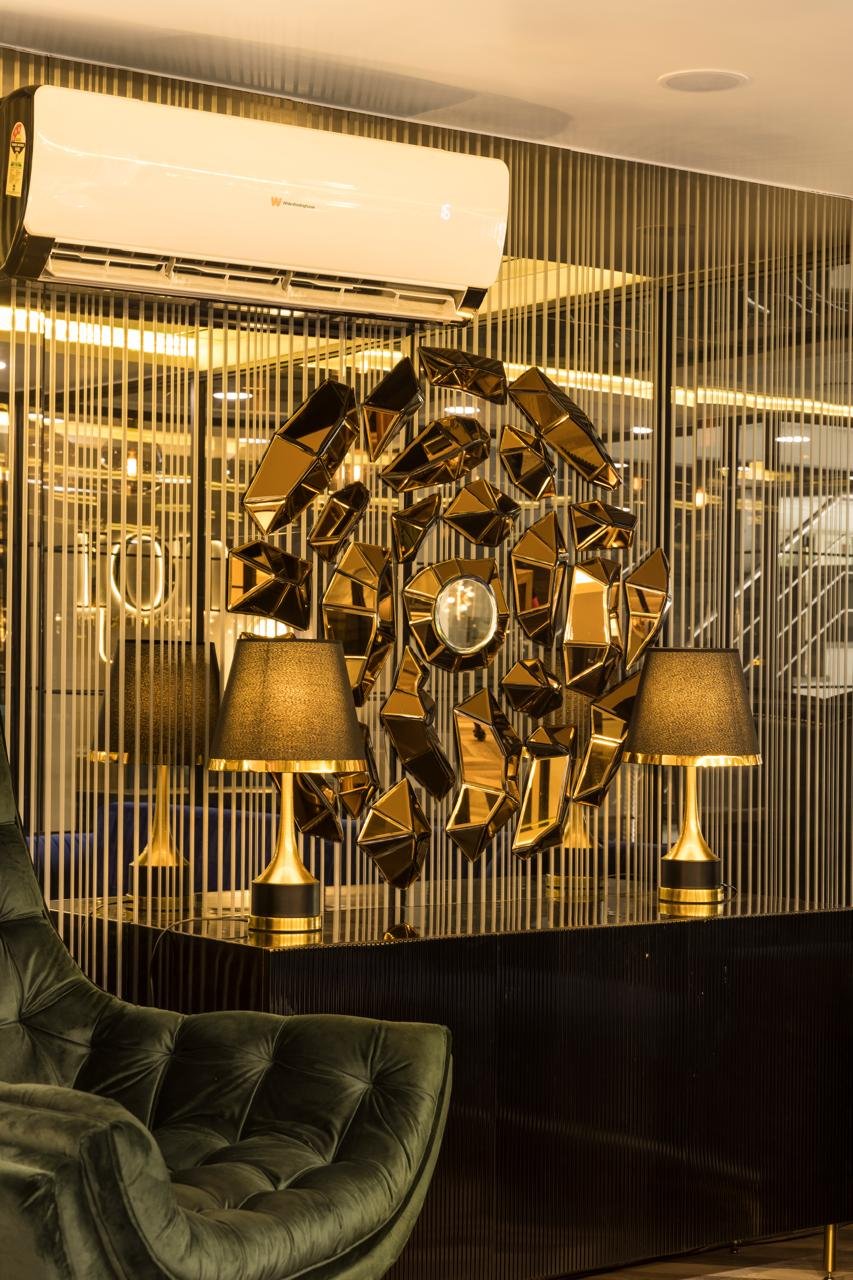 Gold wall art and the TOD logo inside an office seating area